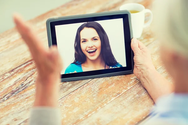 Senior woman with photo on tablet pc at home — Stock Photo, Image