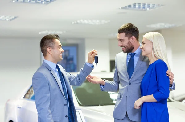 Feliz pareja con concesionario de coches — Foto de Stock