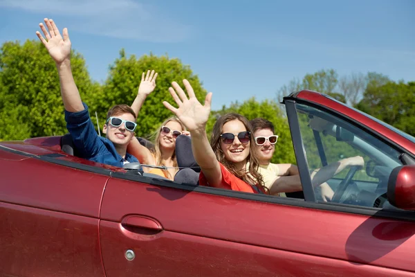 Happy friends driving in cabriolet car — Stock Photo, Image