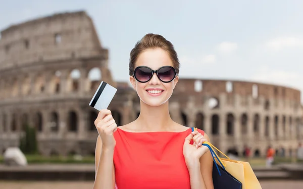 Woman with shopping bags and credit card in rome — Stok fotoğraf