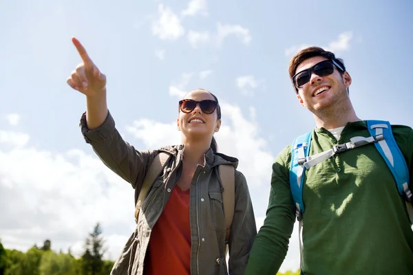Happy couple with backpacks hiking outdoors — Stock Photo, Image
