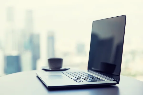 Närbild på laptop och kaffe cup på office tabell — Stockfoto