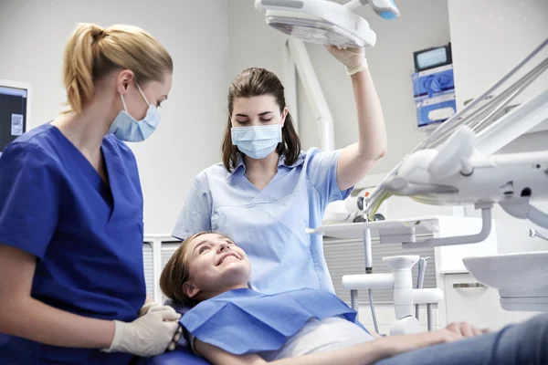 Mutlu kadın dişçi klinikte hasta kızla — Stok fotoğraf