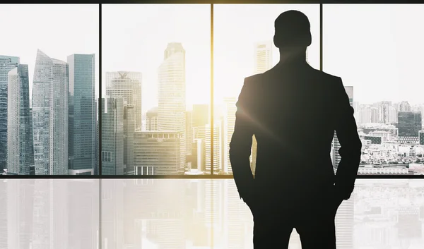 Silhouette of business man over office background — Stock Photo, Image