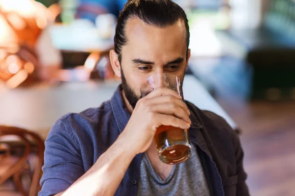 Homem feliz bebendo cerveja no bar ou pub — Fotografia de Stock