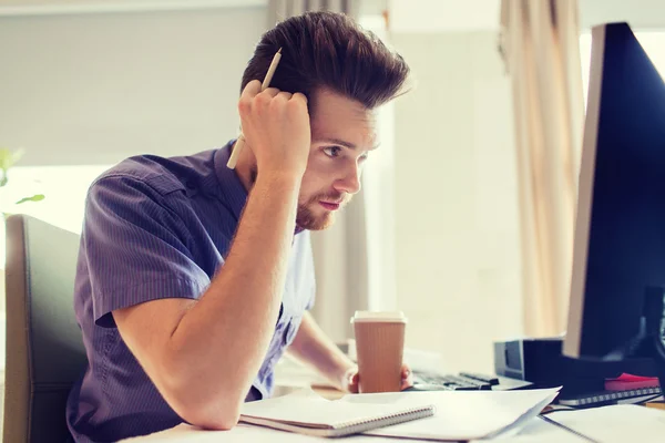 creative male office worker with coffee thinking