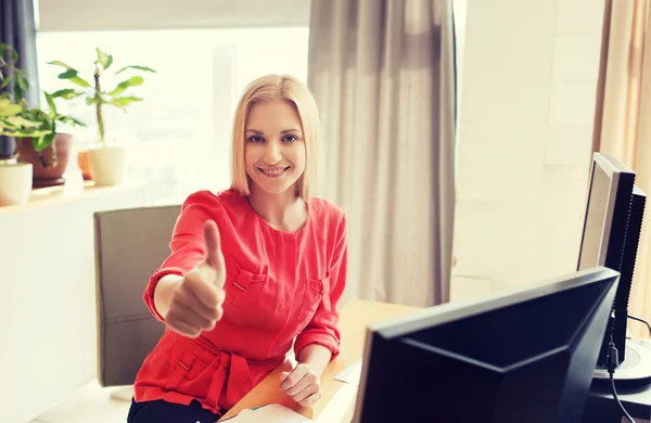 Happy creative female office worker with computers — Stock Photo, Image