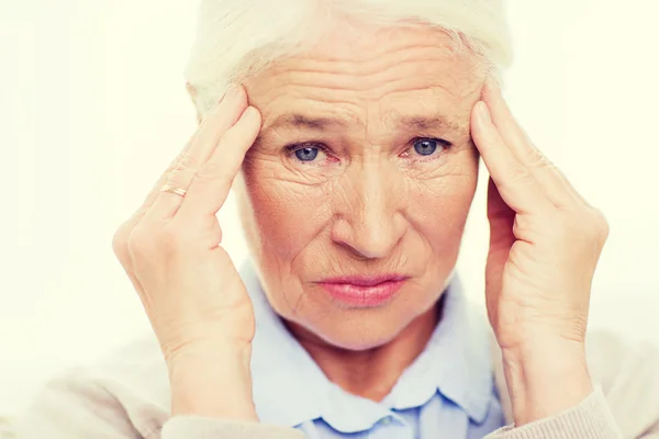 Face of senior woman suffering from headache — Stock Photo, Image