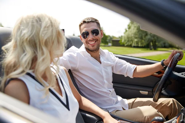 Happy man and woman driving in cabriolet car — Stock Photo, Image