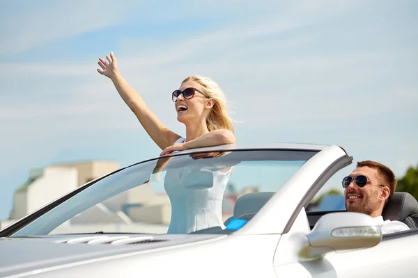 Happy man and woman driving in cabriolet car — Stock Photo, Image