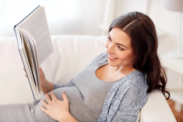 Felice donna incinta leggere libro a casa — Foto Stock