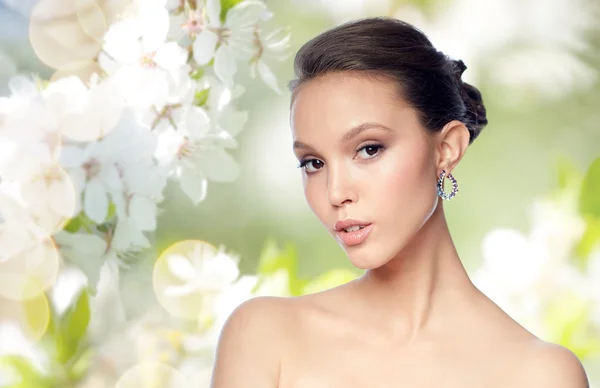 Close up of beautiful woman face with earring — Stock Photo, Image