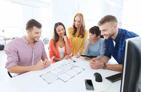 Creative team with blueprint working at office — Stock Photo, Image