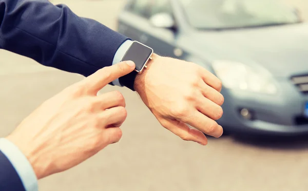 Close up of male hands with wristwatch and car — Stock Photo, Image