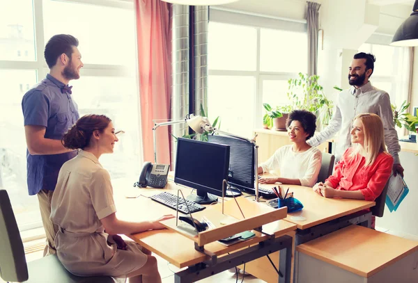 Happy creative team talking in office — Stock Photo, Image