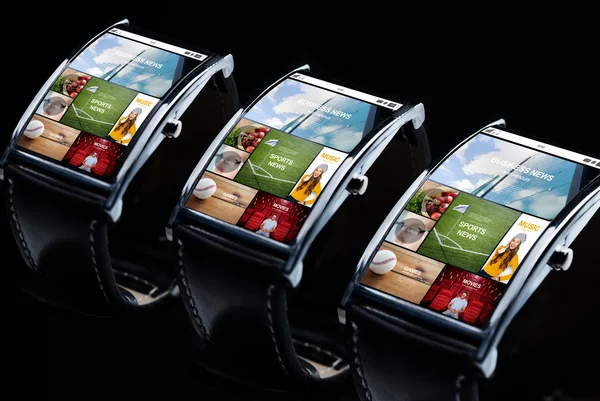 Close up of smart watches with news application — Stock Photo, Image