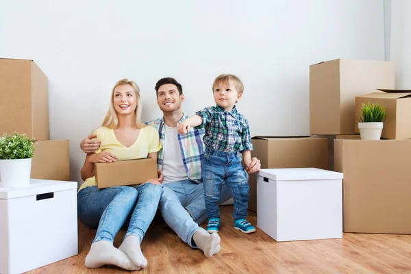 Happy family with boxes moving to new home — Stock Photo, Image