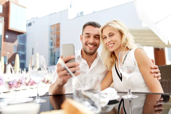 Couple taking selfie with smatphone at restaurant — Stock Photo, Image