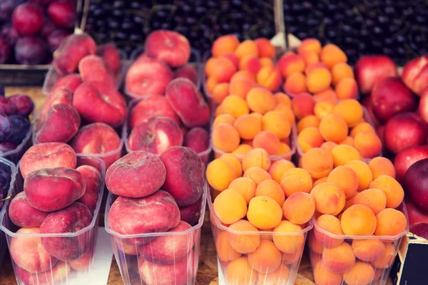 Крупный план персиков и абрикосов на уличном рынке — стоковое фото