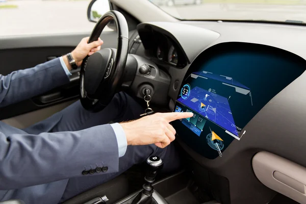 Close up of man driving car with gps navigator map — Stock Photo, Image