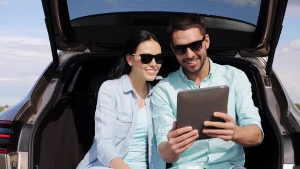 Casal feliz com tablet pc no porta-malas carro hatchback 6 — Vídeo de Stock