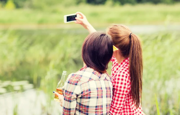 Happy women taking selfie by smartphone outdoors — Stok fotoğraf