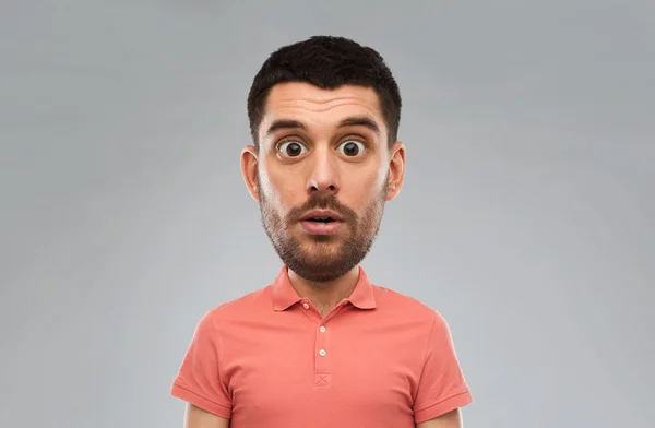 Hombre sorprendido en polo camiseta sobre fondo gris —  Fotos de Stock