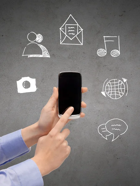 Close up of hands with smartphone and doodles — Stock Photo, Image