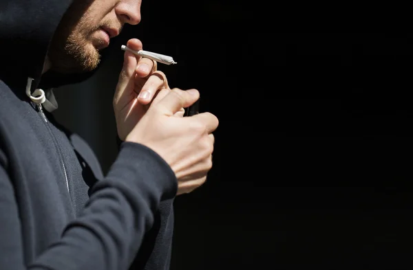 Close up of addict lighting up marijuana joint — Stock Photo, Image