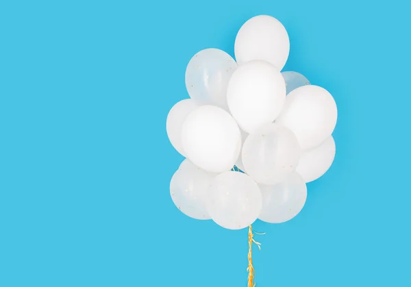 Close up of white helium balloons over blue — Stock Photo, Image