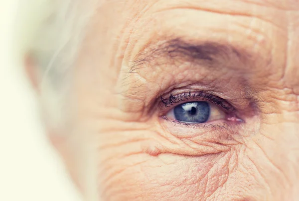 Close up of senior woman face and eye — Stock Photo, Image