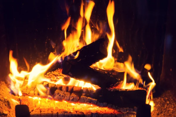 Close up of firewood burning in fireplace — Stock Photo, Image