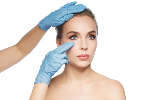 Surgeon or beautician hands touching woman face — Stock Photo, Image