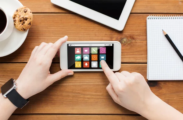 Gros plan de femme avec smartphone sur table en bois — Photo