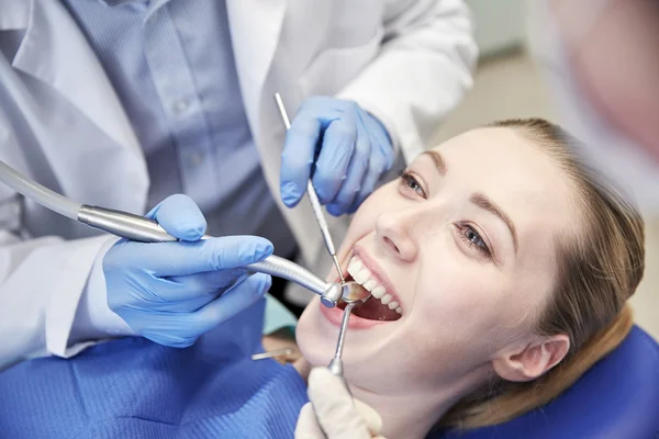Närbild på tandläkare behandla kvinnlig patient tänder — Stockfoto