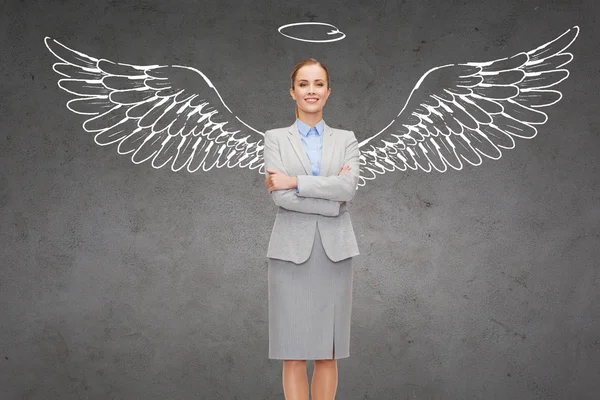 Happy businesswoman with angel wings and nimbus — Stock Photo, Image