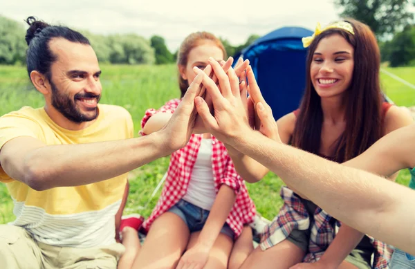 Happy friends making high five at camping — Stock Photo, Image