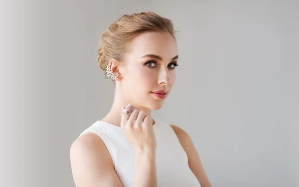 Smiling woman in white dress with diamond jewelry — Stock Photo, Image