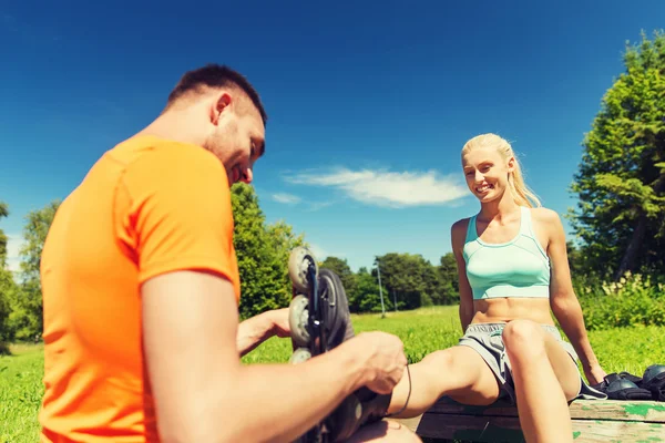 Casal feliz com patins ao ar livre — Fotografia de Stock