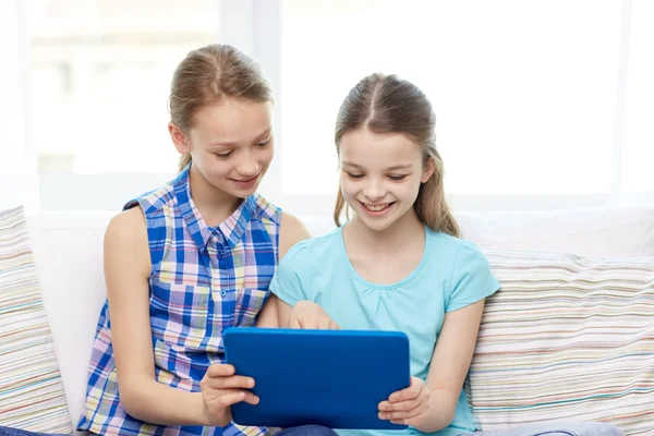 Šťastné dívky s tablet PC sedí na pohovce doma — Stock fotografie