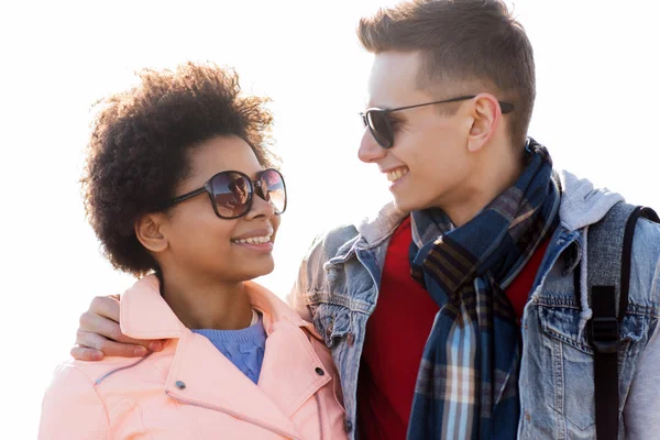 Happy teenage friends in shades talking outdoors — Stock Photo, Image