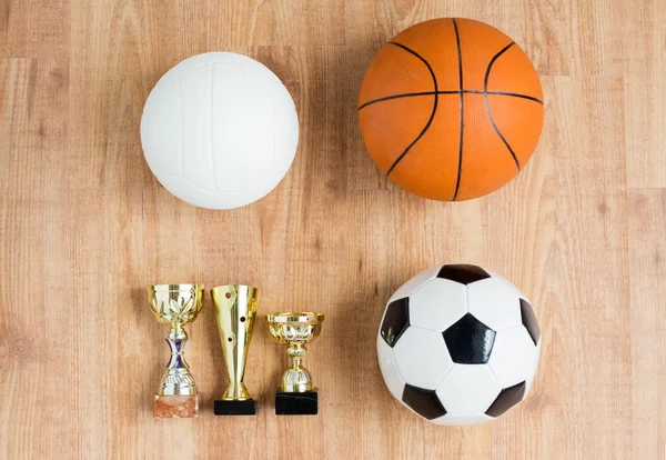 Fútbol, baloncesto, pelotas de voleibol y tazas —  Fotos de Stock