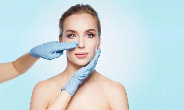 Surgeon or beautician hands touching woman face — Stock Photo, Image