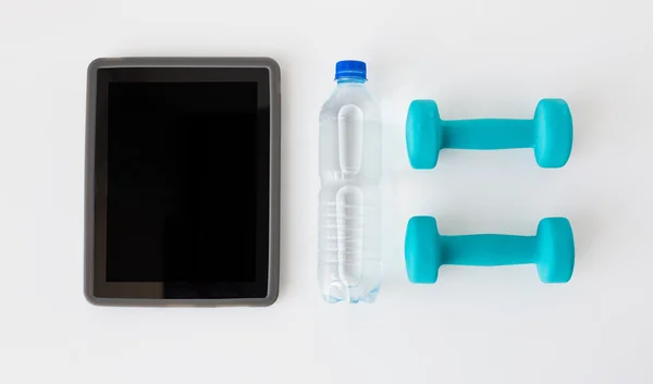 Close up of tablet pc, dumbbells and water bottle — Stock Photo, Image