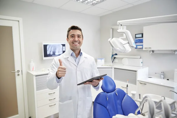 Happy dentist showing thumbs up with tablet pc — Stock Photo, Image