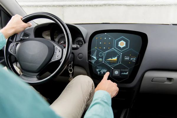 Close up of man driving car with diagram on screen — Stock Photo, Image