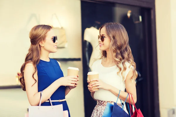 Junge Frauen mit Einkaufstaschen und Kaffee im Laden — Stockfoto