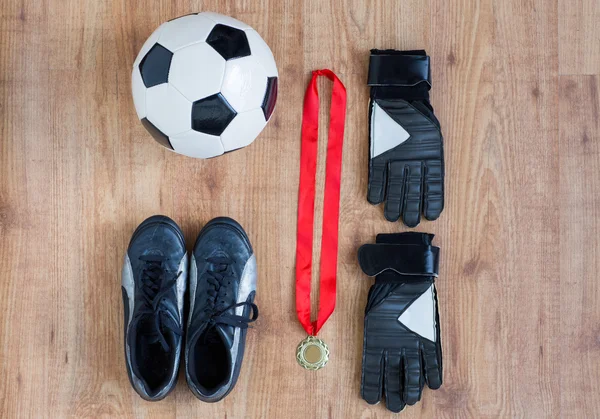 Close up of soccer ball, boots, gloves and medal — Stock Photo, Image