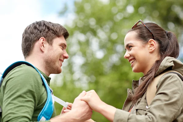 Happy couple with backpacks hiking outdoors — Stock Photo, Image