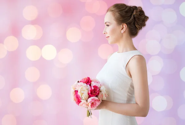 Bride or woman in white dress with flower bunch — Stock Photo, Image